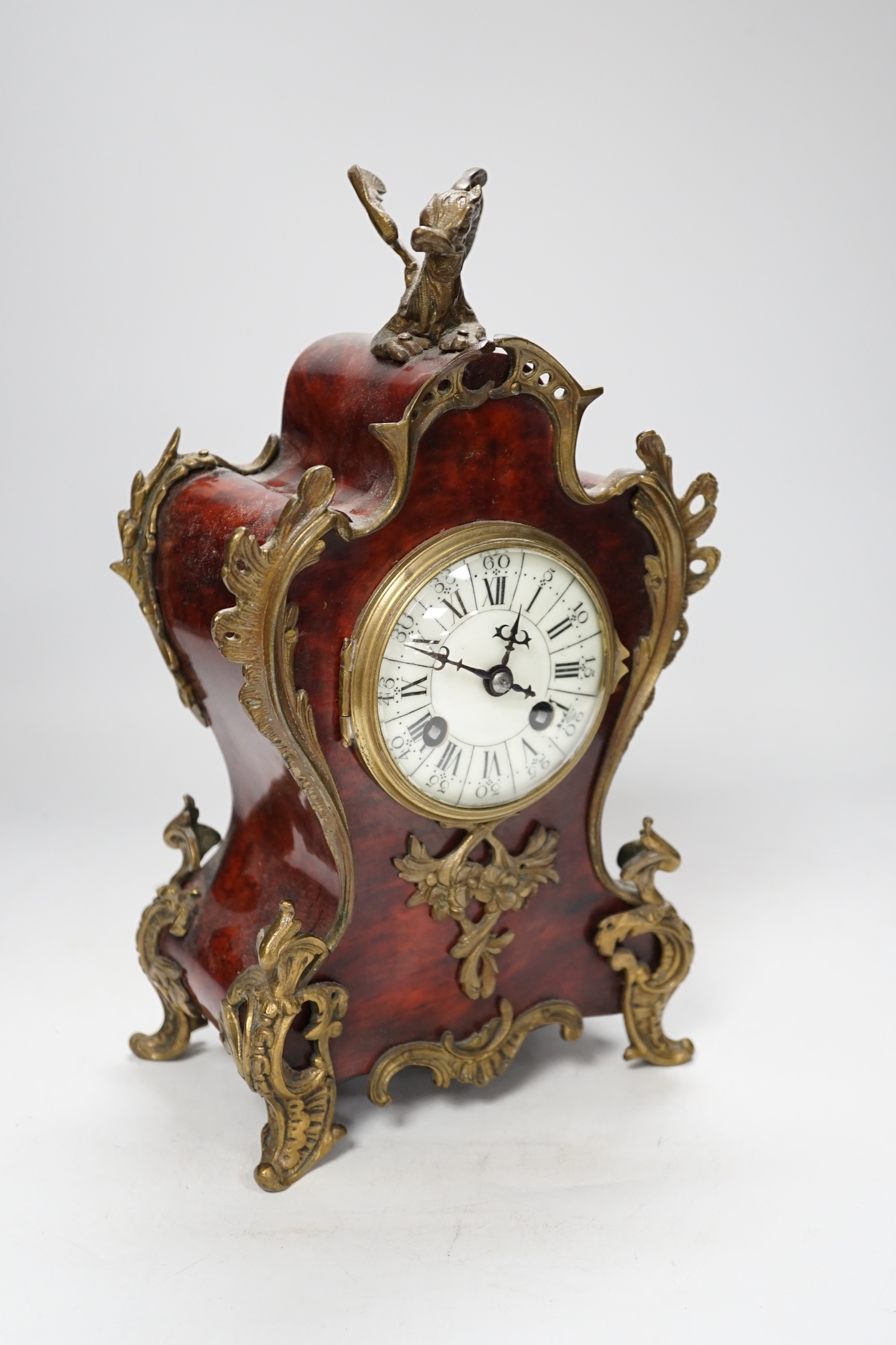 An early 20th century French red tortoiseshell veneered mantel clock with dragon mount, 30cm